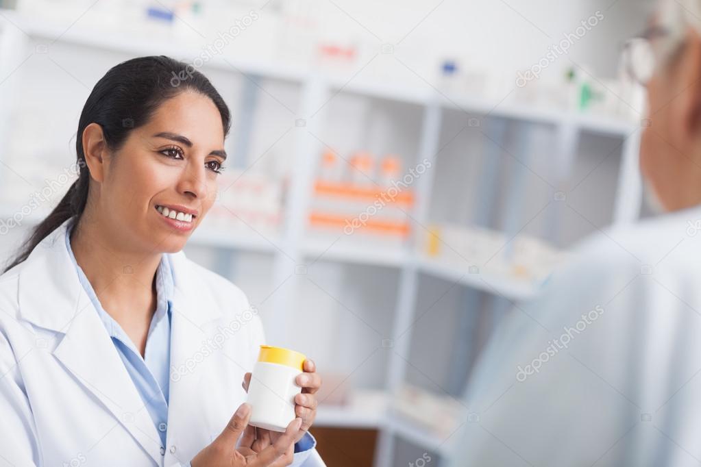 Senior choosing prescriptions at a local pharmacy counter.
