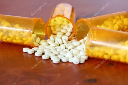 Senior picking up prescription medications at a pharmacy.